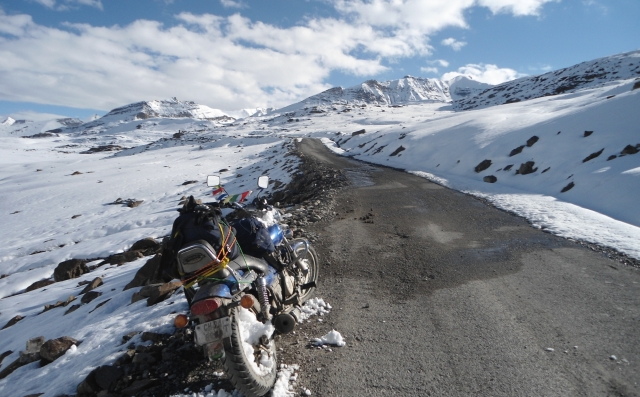 bajaj avenger on a trail through snow covered mountains